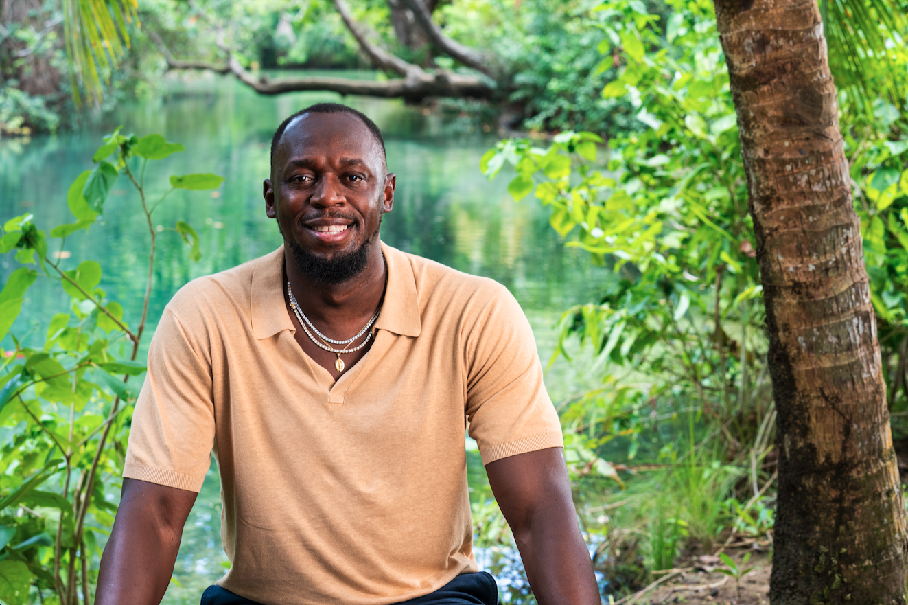 A person sitting in front of a body of waterAI-generated content may be incorrect.