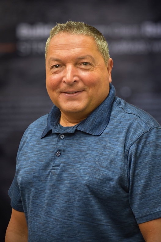 A person in a blue polo shirtAI-generated content may be incorrect.