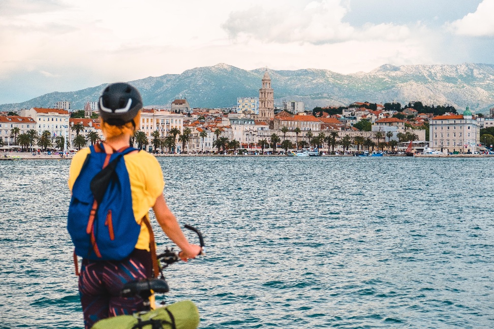 A person on a bicycle looking at a cityAI-generated content may be incorrect.