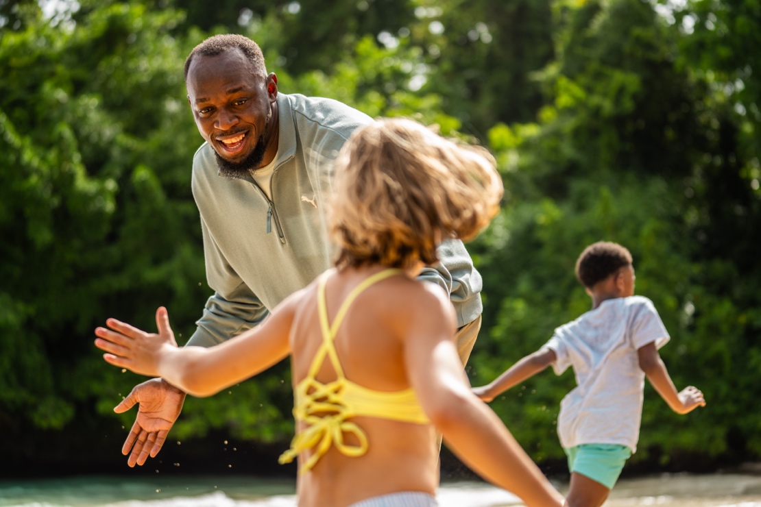 A person and children playing with waterAI-generated content may be incorrect.